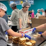 MSD DECA Students Make 1,300 PB&J Sandwiches for Day of Service and Love